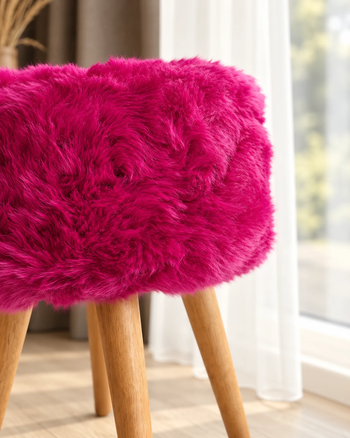Close-up of the fuchsia pink sheepskin seat edge and oak legs by the window