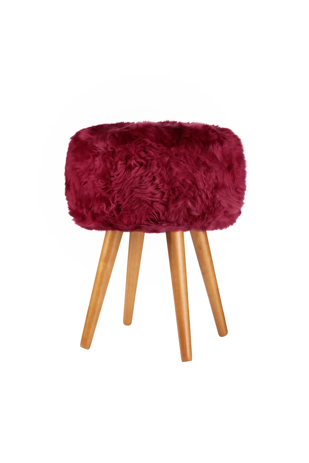 Fuchsia Pink genuine sheepskin stool showing all four oak legs on a white background